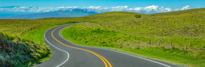 A lone road curving through open hills on Hawaii's Big Island