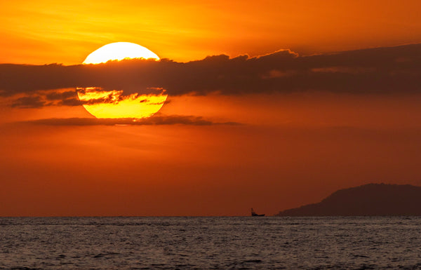 A blazing sunset and a lone boat off Costa Rica's Pacific coast