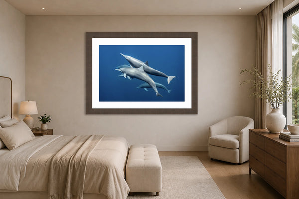Blue Harmony spinner dolphin pod fine art print framed in a serene luxury primary bedroom