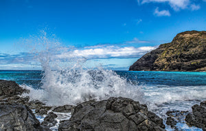 Crashing Waves fine art print — a powerful Hawaiian wave breaking over black volcanic rock beside a rugged turquoise coast