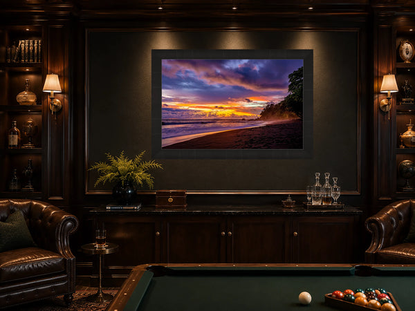 Dreamland Costa Rica sunset fine art print framed and lit on the feature wall of a moody luxury billiards and games room with leather chesterfields