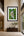 El Rey rainforest waterfall fine art print framed on a tall warm limewash wall in a serene double-height modern entry and staircase gallery