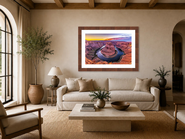 Horseshoe Bend Arizona sunset fine art print framed above a linen sofa in an elegant warm transitional luxury living room with soft neutral tones