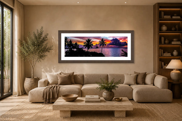 Island Dreamer panoramic Hawaiian tropical sunset fine art print framed above a long low sectional in a warm earthy modern luxury living room