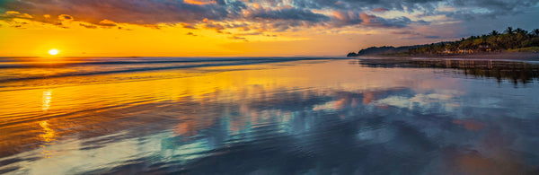 Mirror for the Sun panoramic fine art print of a golden sunset reflected on a wet tropical beach