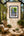 Jungle Oasis rainforest waterfall fine art print framed on a tall plaster wall in a bright luxury glass conservatory and garden room with palms and ferns