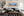Portland Head Light Maine lighthouse panoramic fine art print framed in walnut above a navy sofa in a traditional New England coastal living room