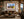 Roxborough Colorado red rock autumn fine art print framed in walnut above a leather sofa in a warm mountain-modern lodge living room