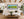 Saddle Road Hawaii panoramic green hills fine art print framed in black above a linen sofa in a bright modern farmhouse living room