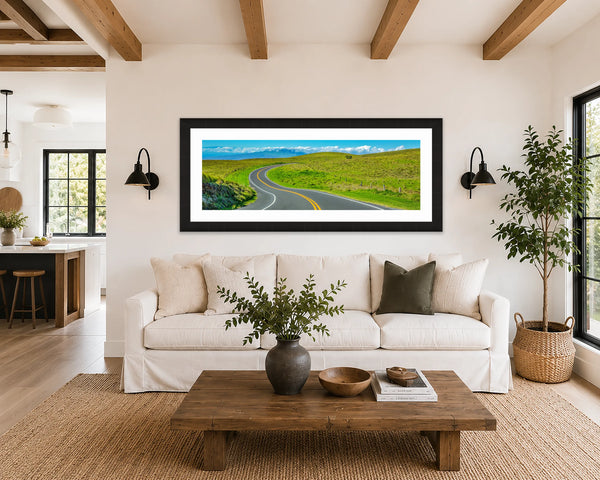 Saddle Road Hawaii panoramic green hills fine art print framed in black above a linen sofa in a bright modern farmhouse living room