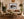 Sloth Crossing close-up portrait fine art print framed in walnut above a sofa in a warm bohemian living room with plants