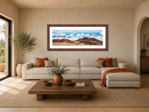Summit of the Sky volcanic cinder cone panorama framed above a linen sofa in a warm earthy-contemporary living room
