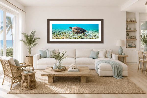 Tranquil Tides sea turtle panorama framed above a sofa in a bright relaxed coastal living room