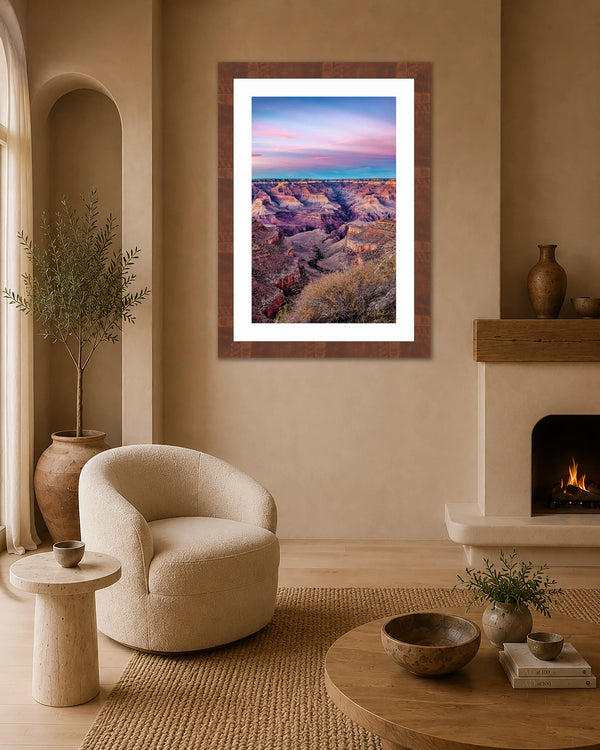 Tranquility Grand Canyon twilight print framed on a clay-plaster wall in a warm desert-modern living room