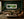 Trogan Falls rainforest waterfall panorama framed on a deep emerald wall in a lush jewel-tone living room
