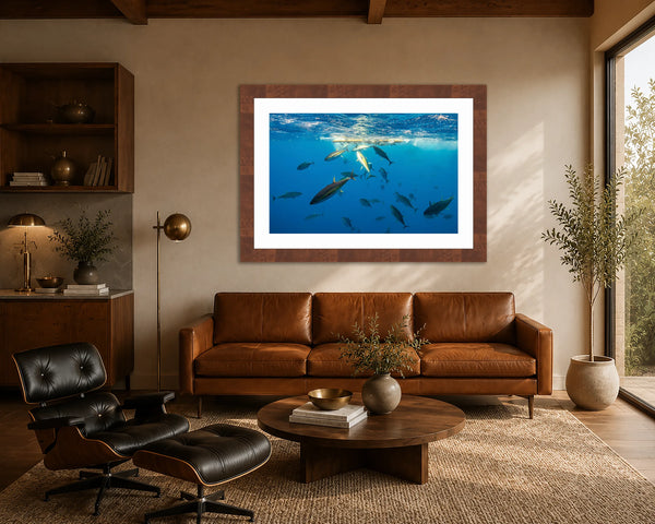 Wicked Tuna yellowfin tuna print framed above a cognac leather sofa in a warm mid-century modern living room